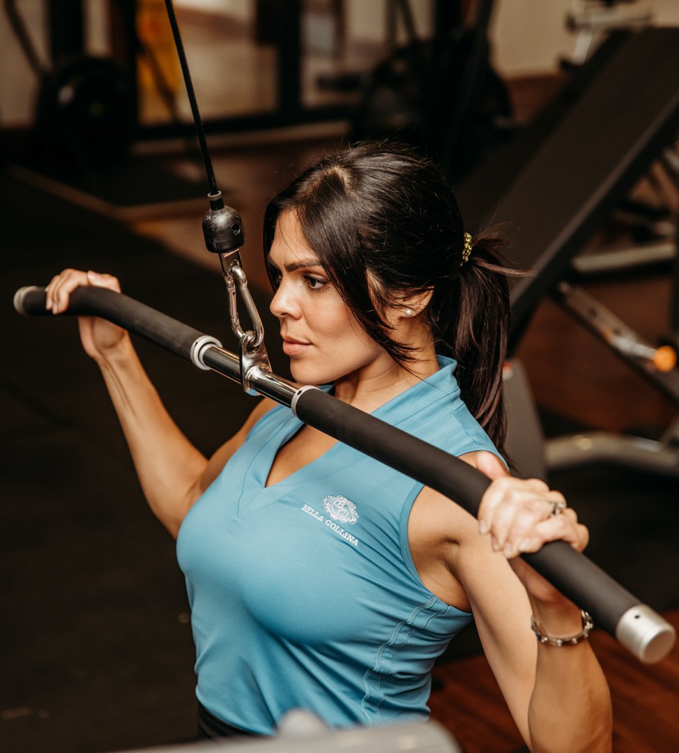 Woman at lat pulldown machine at Bella Collina fitness center