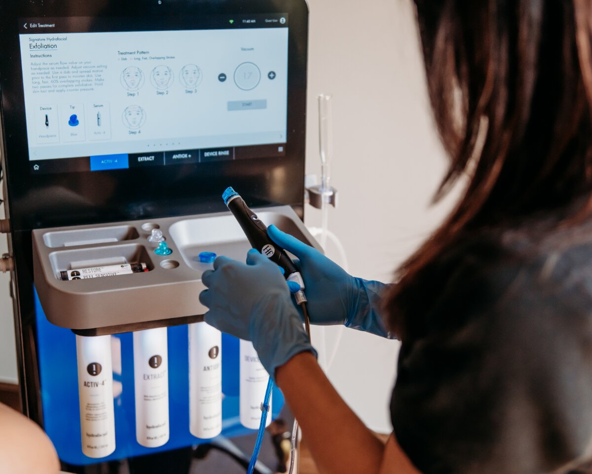 Esthetician preparing HydraFacial equipment at The Spa at Bella Collina