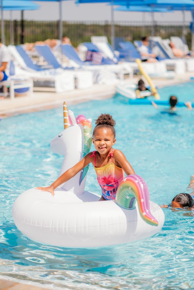 Girl on Float at Bella Collina Luxury Pool