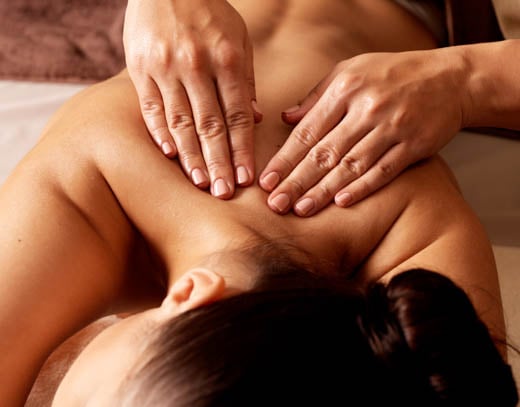 Woman receiving a back massage at The Spa at Bella Collina