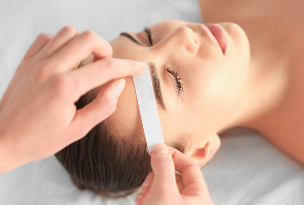 Woman getting her eyebrows waxed