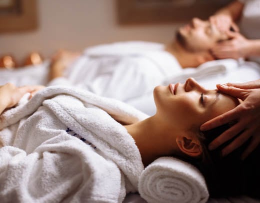 Couples receiving at massage at the Spa at Bella Collina