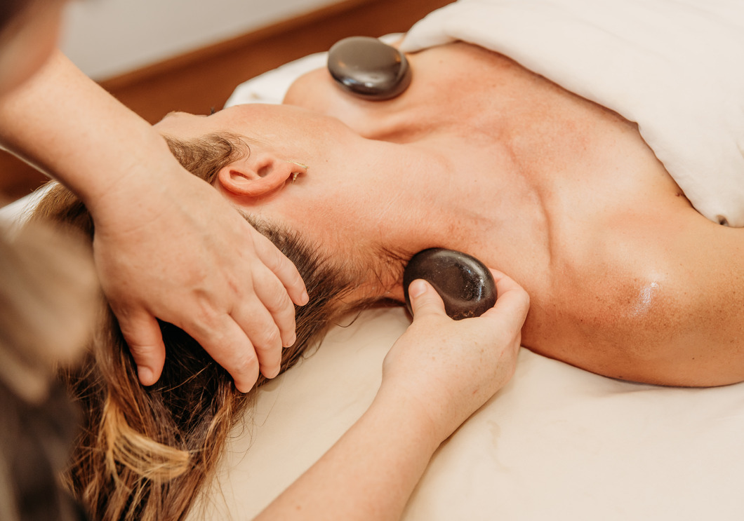 Woman receiving a hot stone massage at The Spa at Bella CollinaDSC_3894-1060px