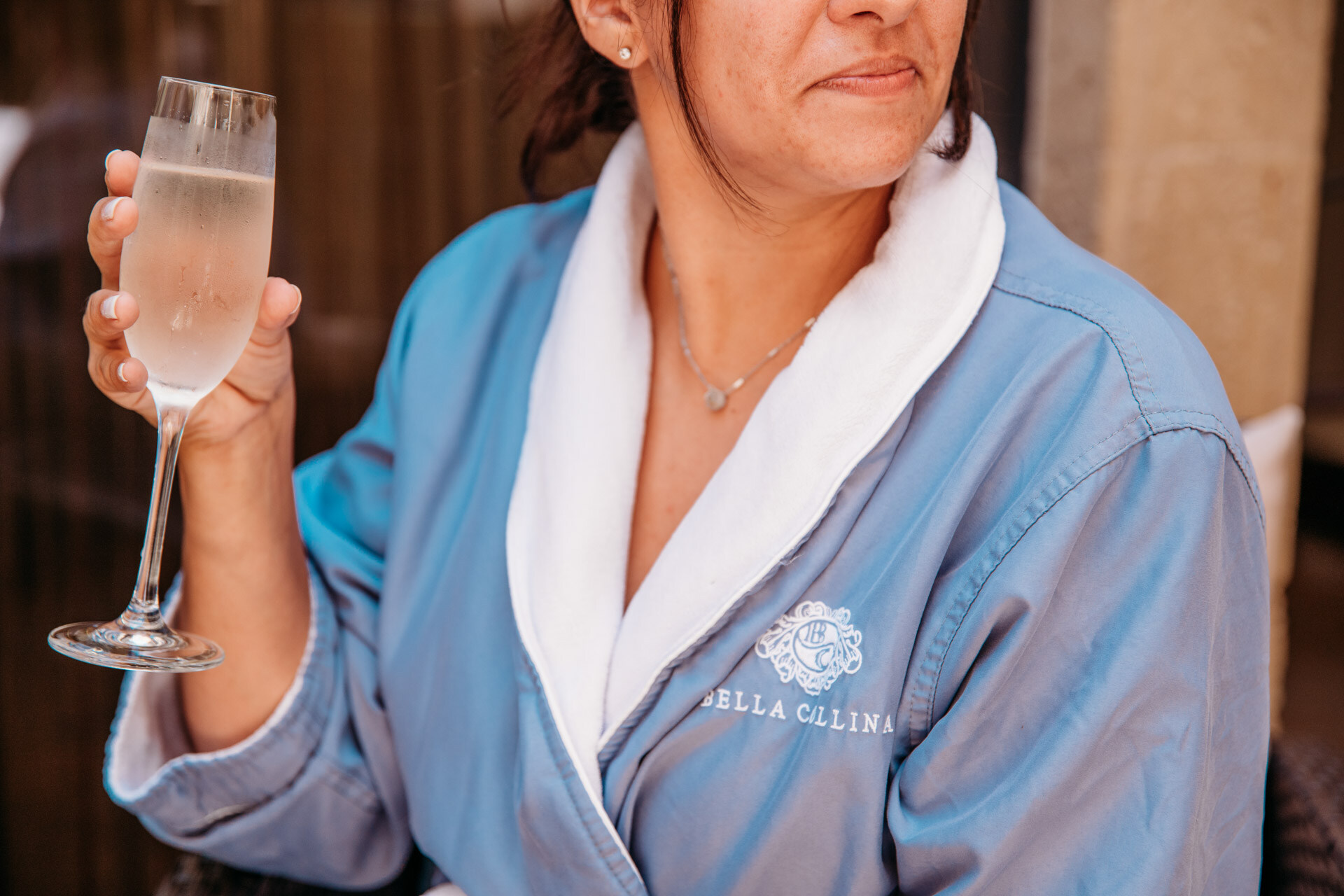 Woman in a Bella Collina spa robe after a HydraFacial Neck & Décolleté treatment