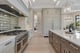 J. Drewes luxury custom kitchen with large island and professional range at Bella Collina