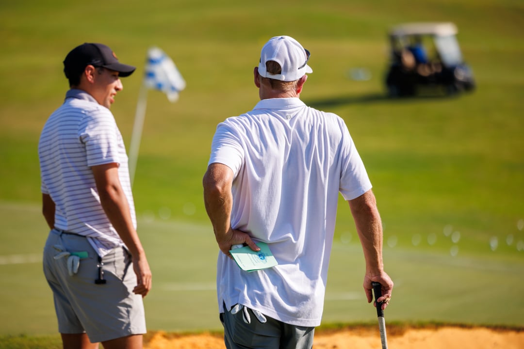 Men standing at Bella Collina golf green