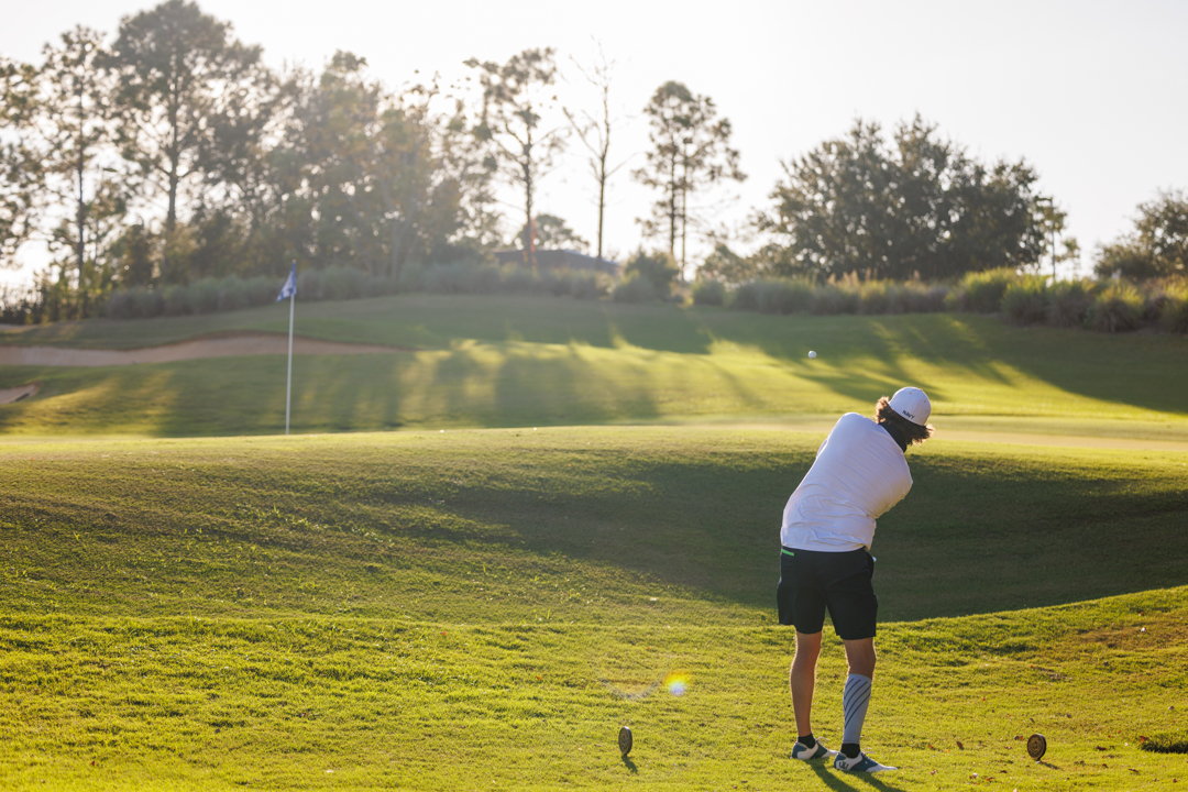 Golfer hitting an approach shot on the Bella Collina golf course