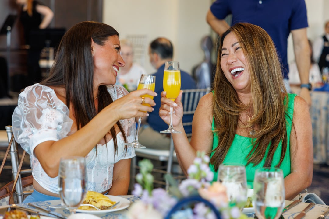 Friends laughing at Bella Collina member event