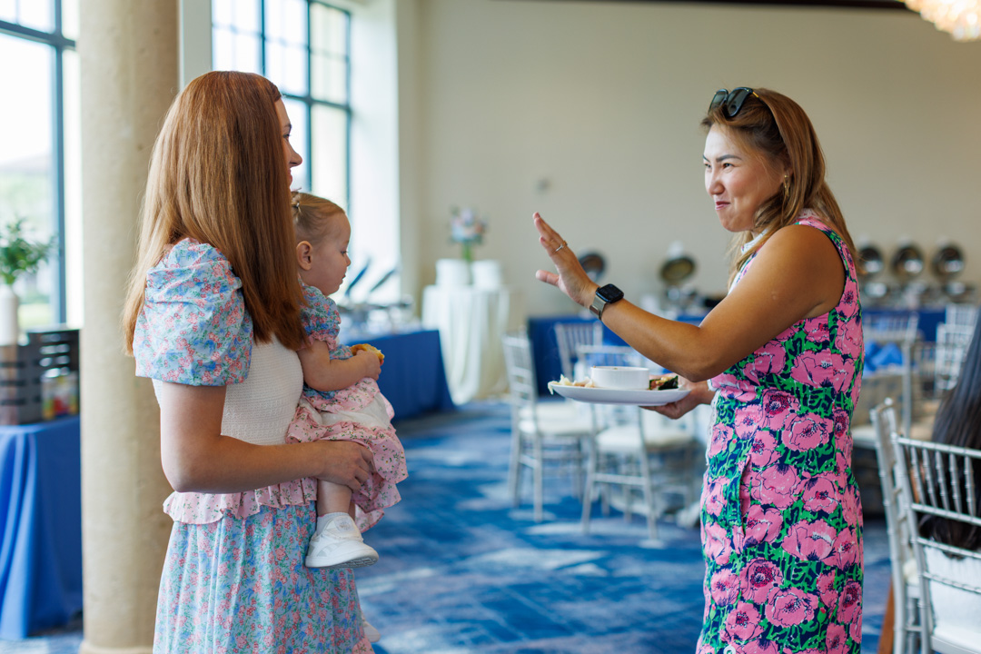Women conversing at Bella Collina member event