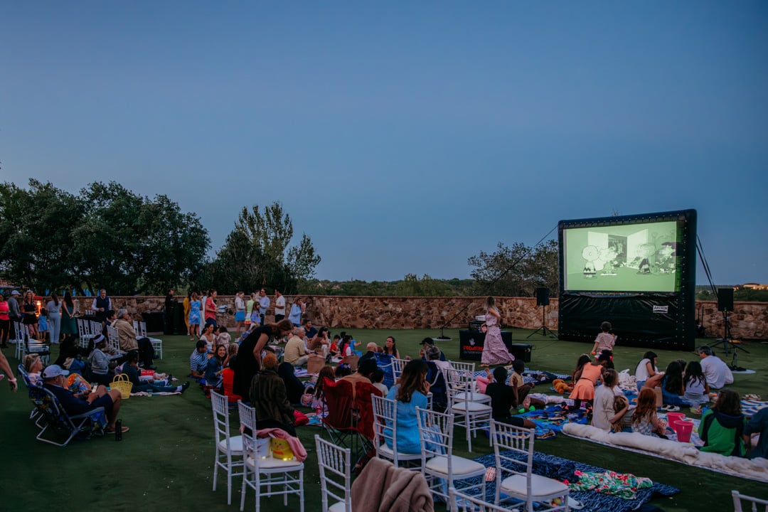 People attending outdoor movie at Bella Collina member event