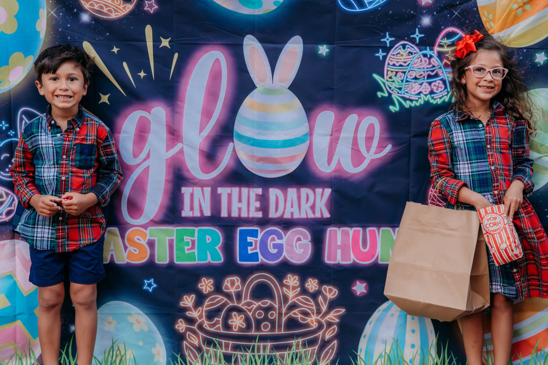 Children standing in front of an Easter Egg Hunt display sign at Bella Collina