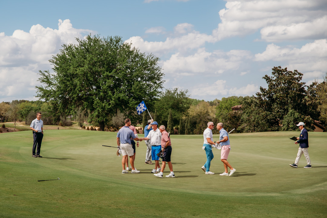 Group of men shaking hands after finishing a round of golf at Bella Collina