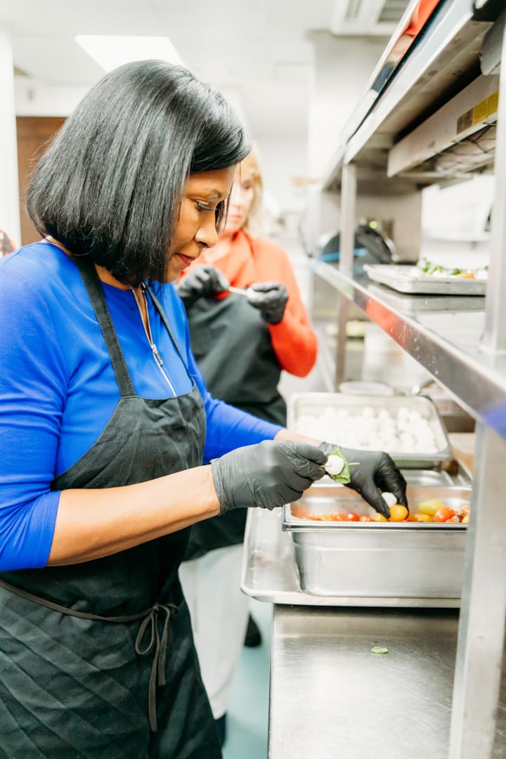 Woman preparing food at Bella Collina event