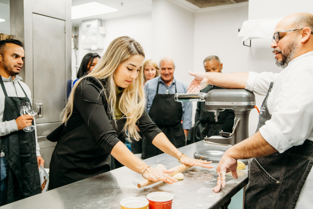 Woman rolling dough at Bella Collina event
