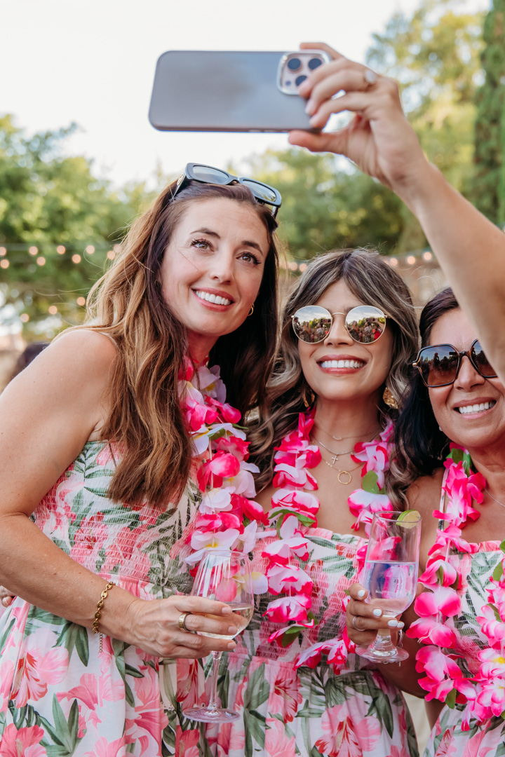 Women wearing leis at Bella Collina event