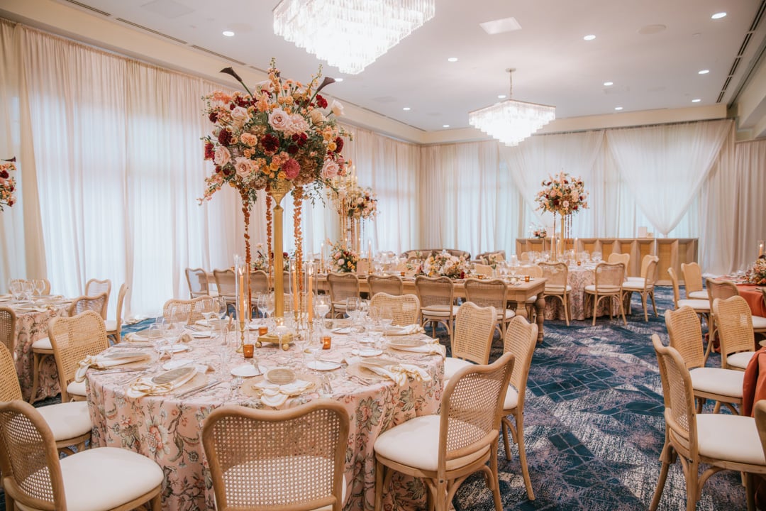 Elegant ballroom reception setup with floral centerpieces at Bella Collina