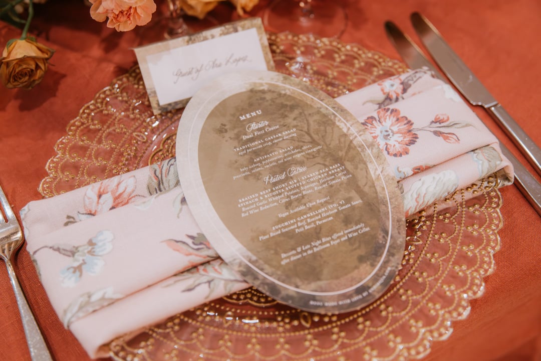 Wedding menu displayed on an elegant place setting at Bella Collina