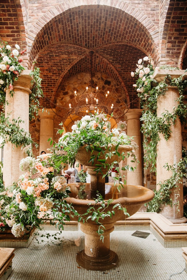 Elegant floral display beneath brick arches at Bella Collina