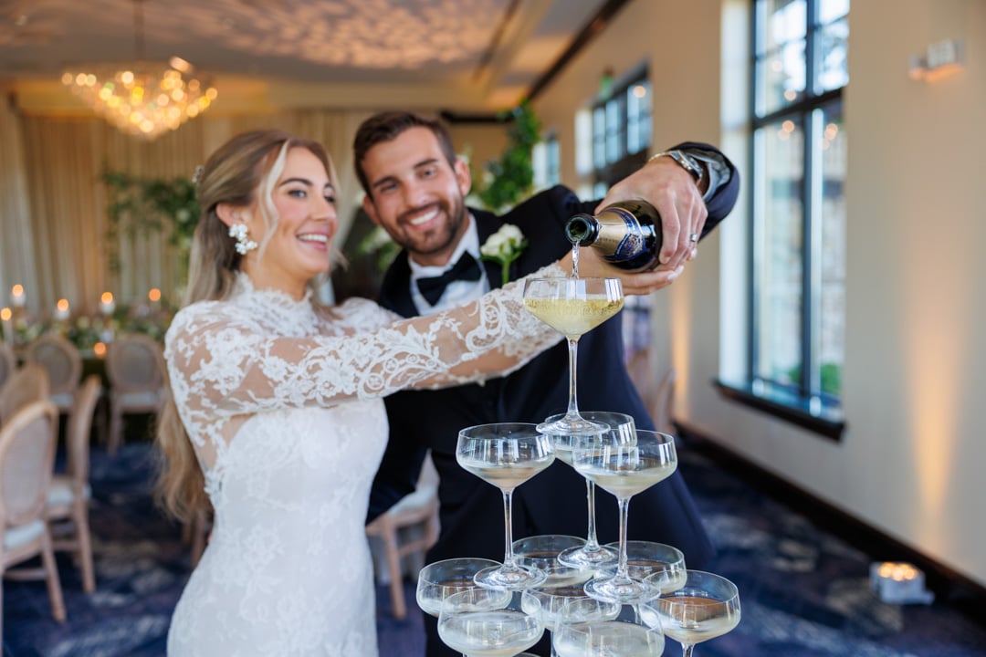 Bride and groom pouring champagne in glasses