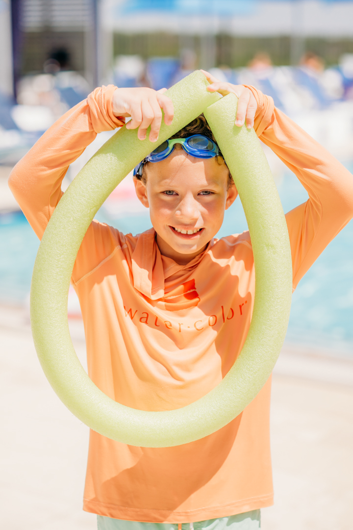 Boy Holding Noodle at La Piscina Pool Party