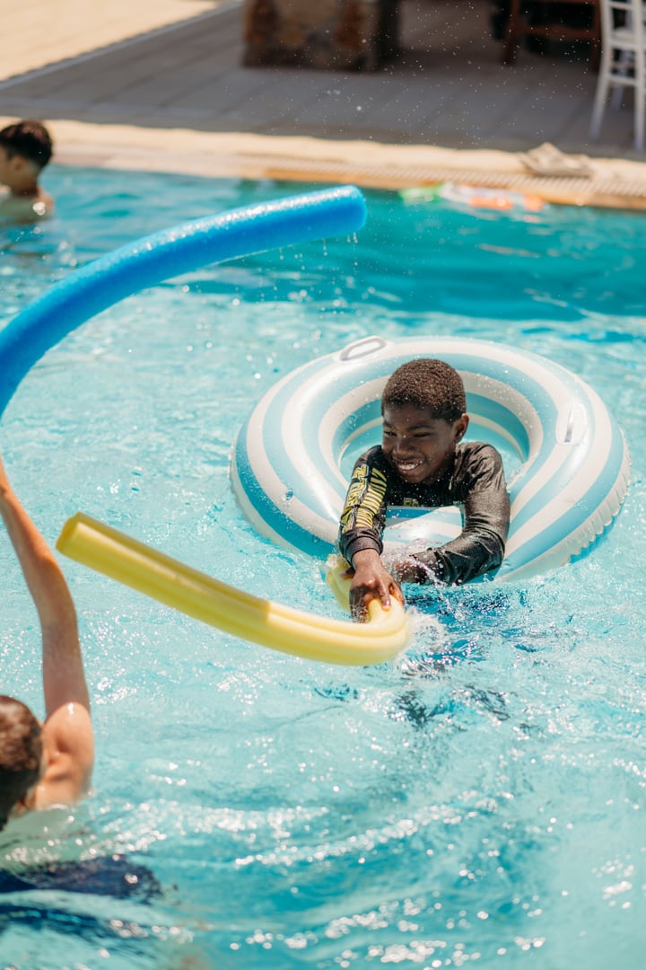 Boy Playing with Noodle at La Piscina Pool Party