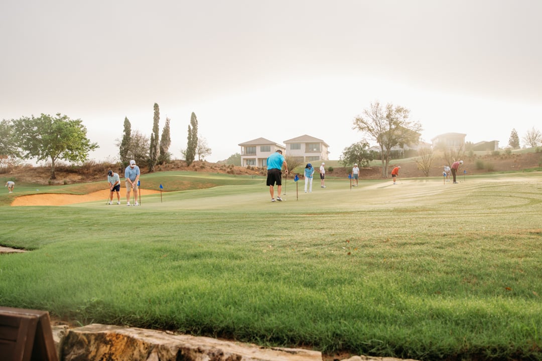 Players putting on Bella Collina Practice Facility