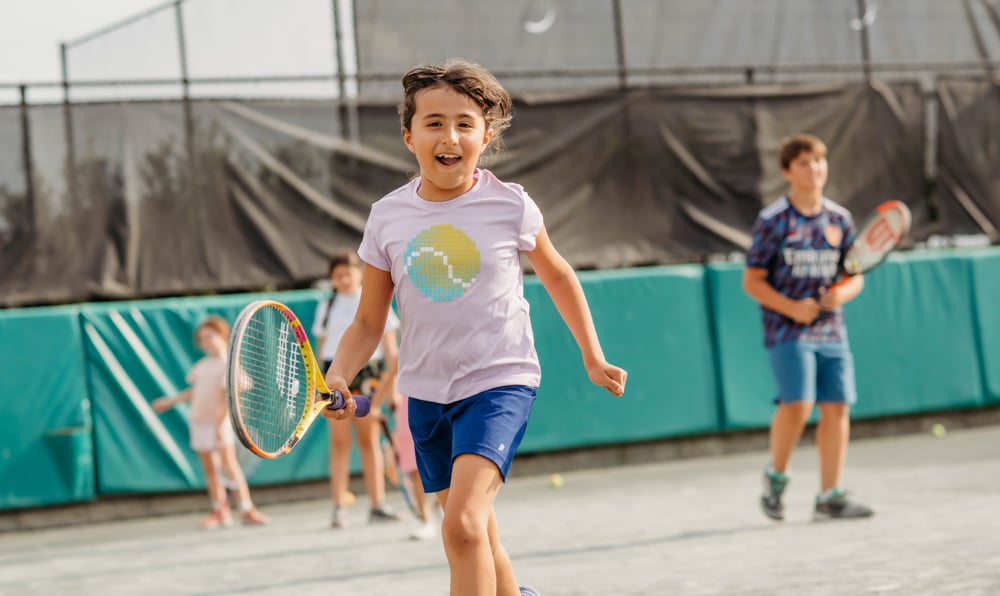 Kids playing tennis during youth tennis lessons at Bella Collina