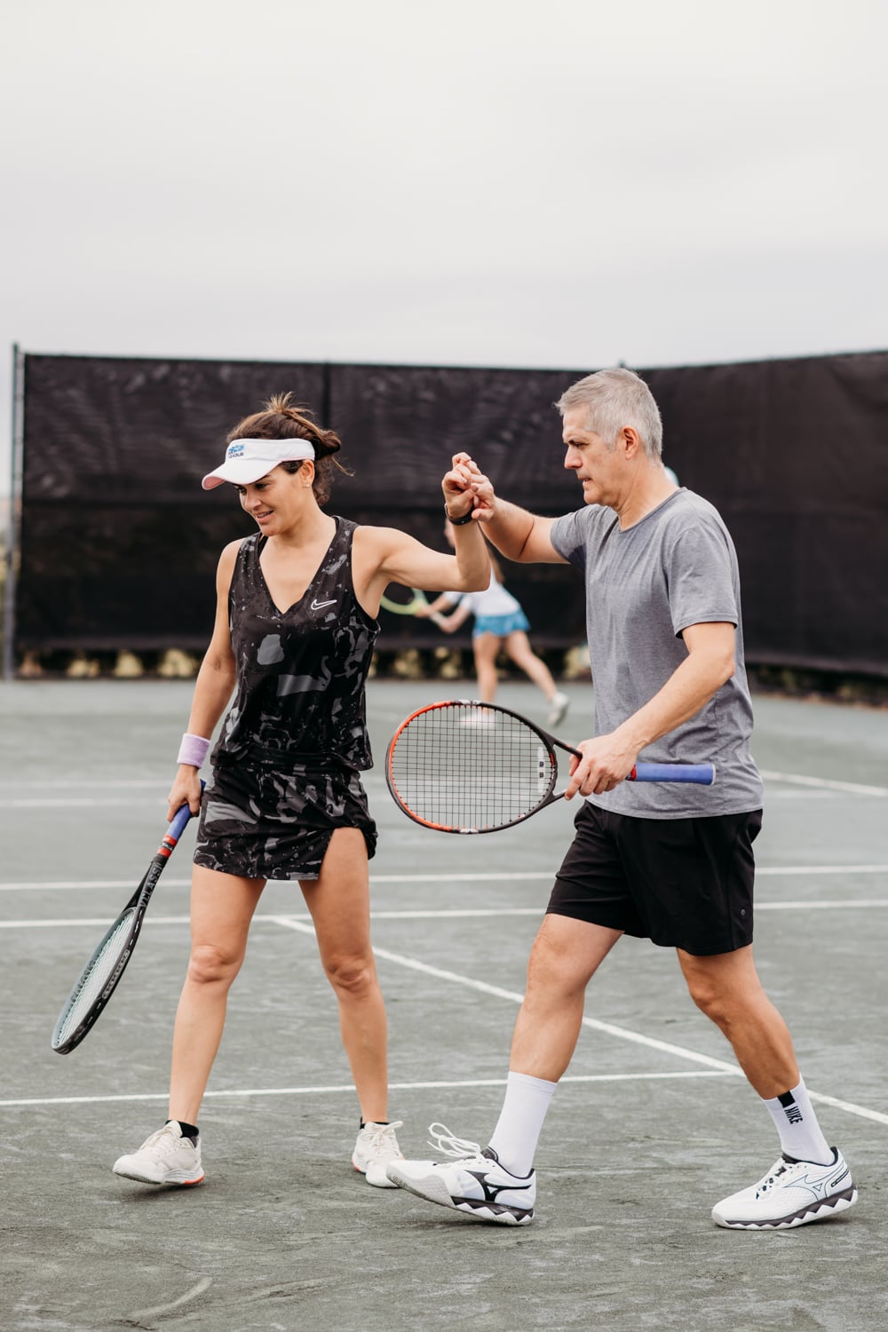 Man and woman congratulating each other after a tennis match at Bella Collina