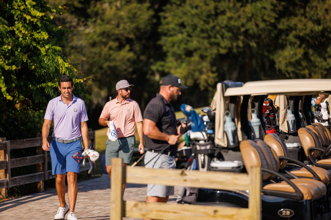 Bella Collina Tournament players at golf carts