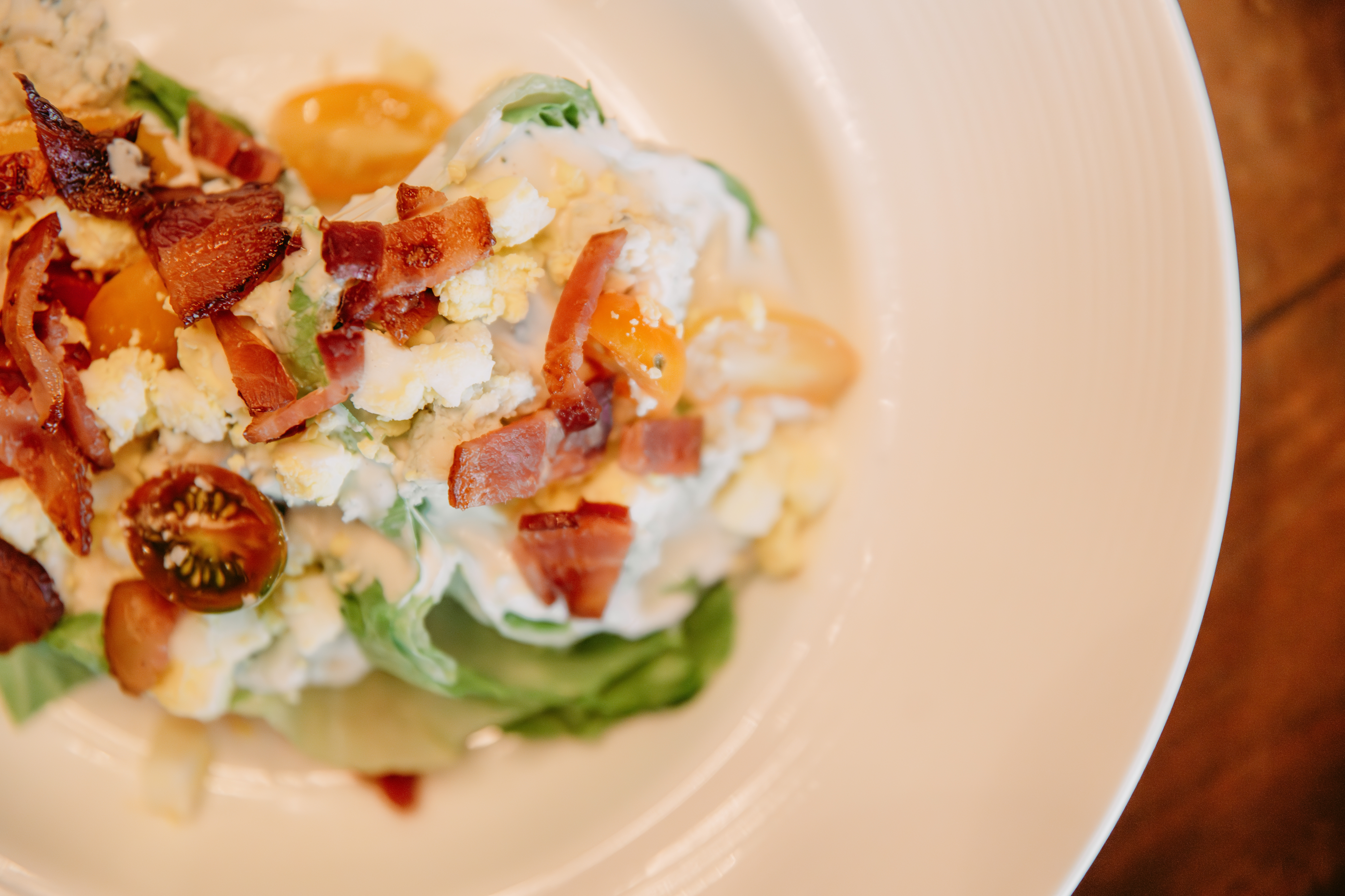 Fresh cobb salad topped with bacon and egg at Bella Collina