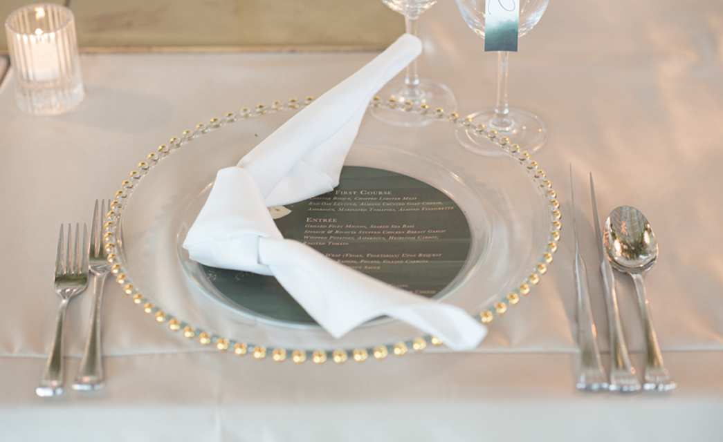 Elegant place setting with wedding menu and folded napkin at Bella Collina wedding tasting event