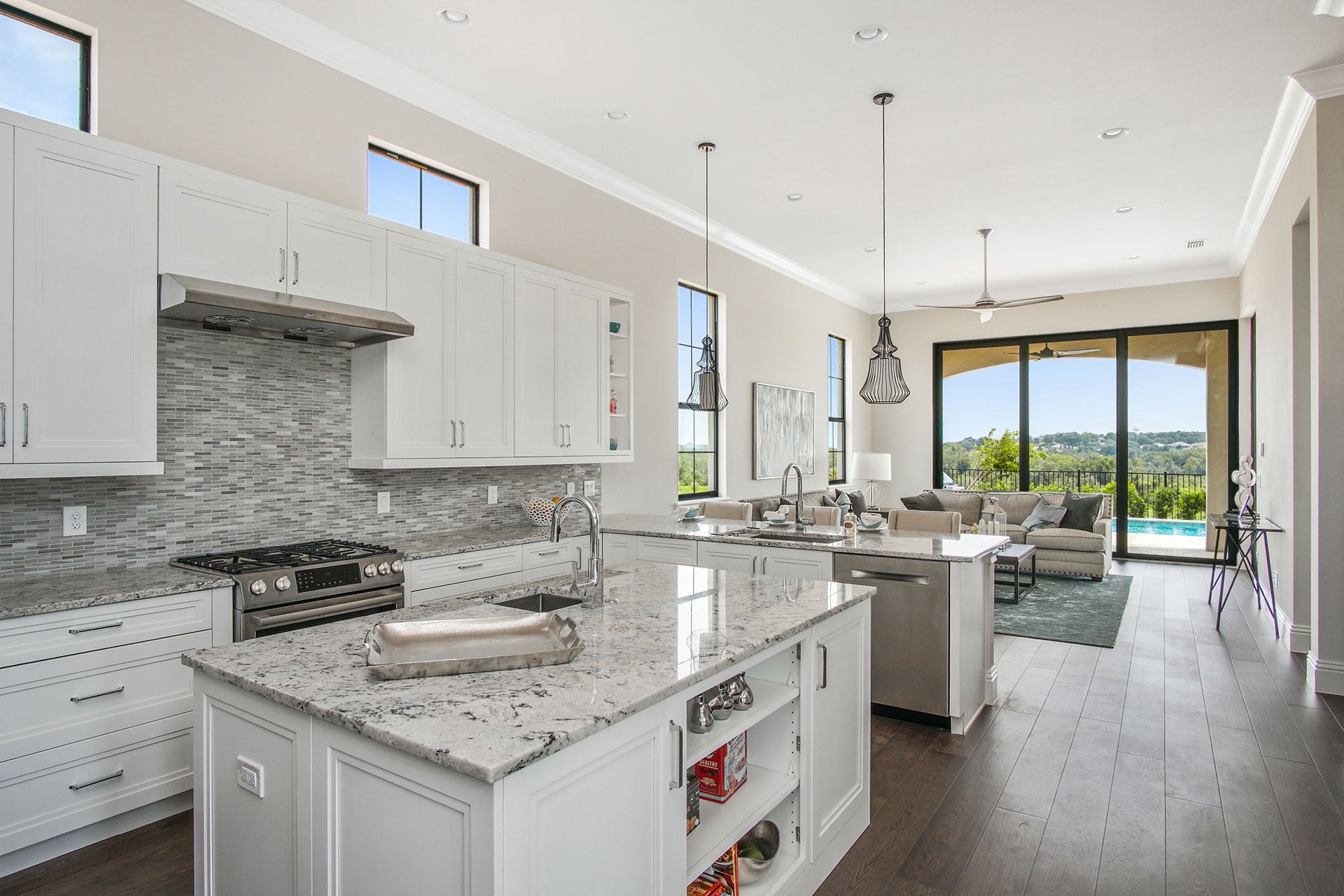 Luxury open-concept kitchen and living area with pool views in a Bella Collina home