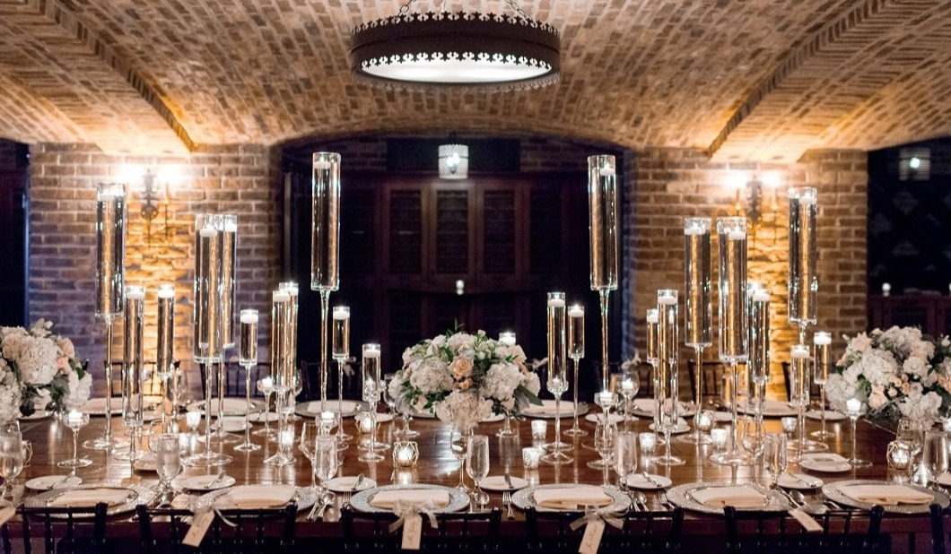 Elegant table setting with candles and floral arrangements in the Wine Cellar at Bella Collina