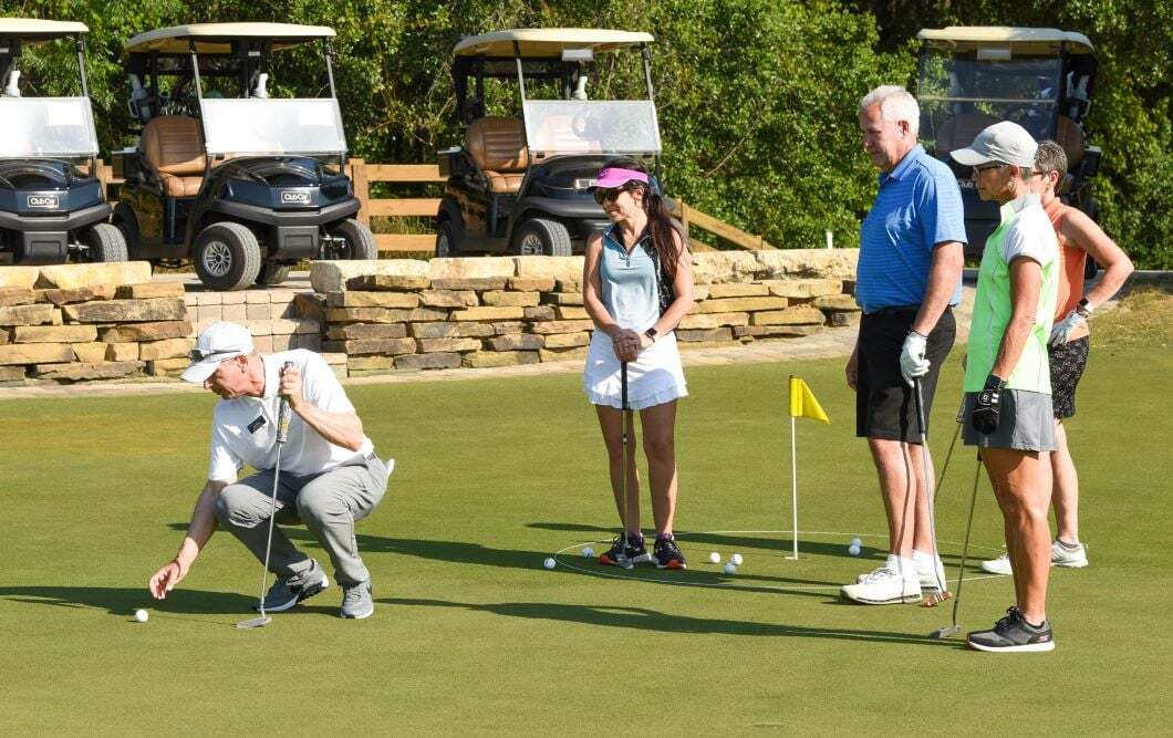 Bella Collina Golf Academy students receiving putting lesson from Pro