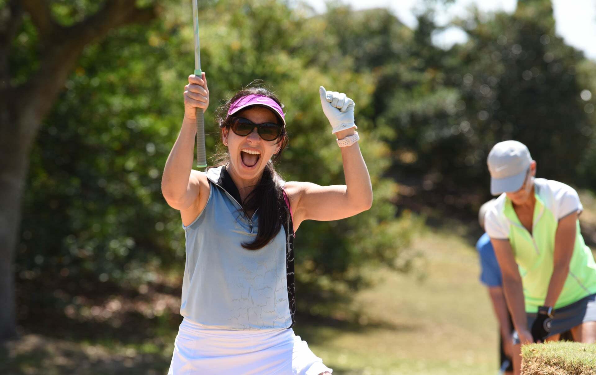 Woman celebrating golf shot