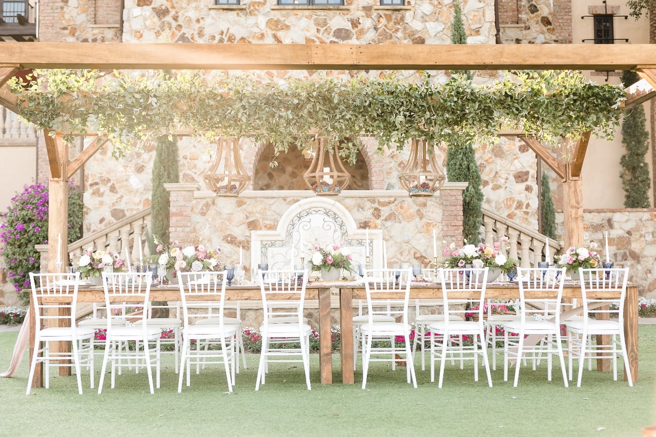 Grand Lawn event with white chairs, greenery, and floral décor at Bella Collina