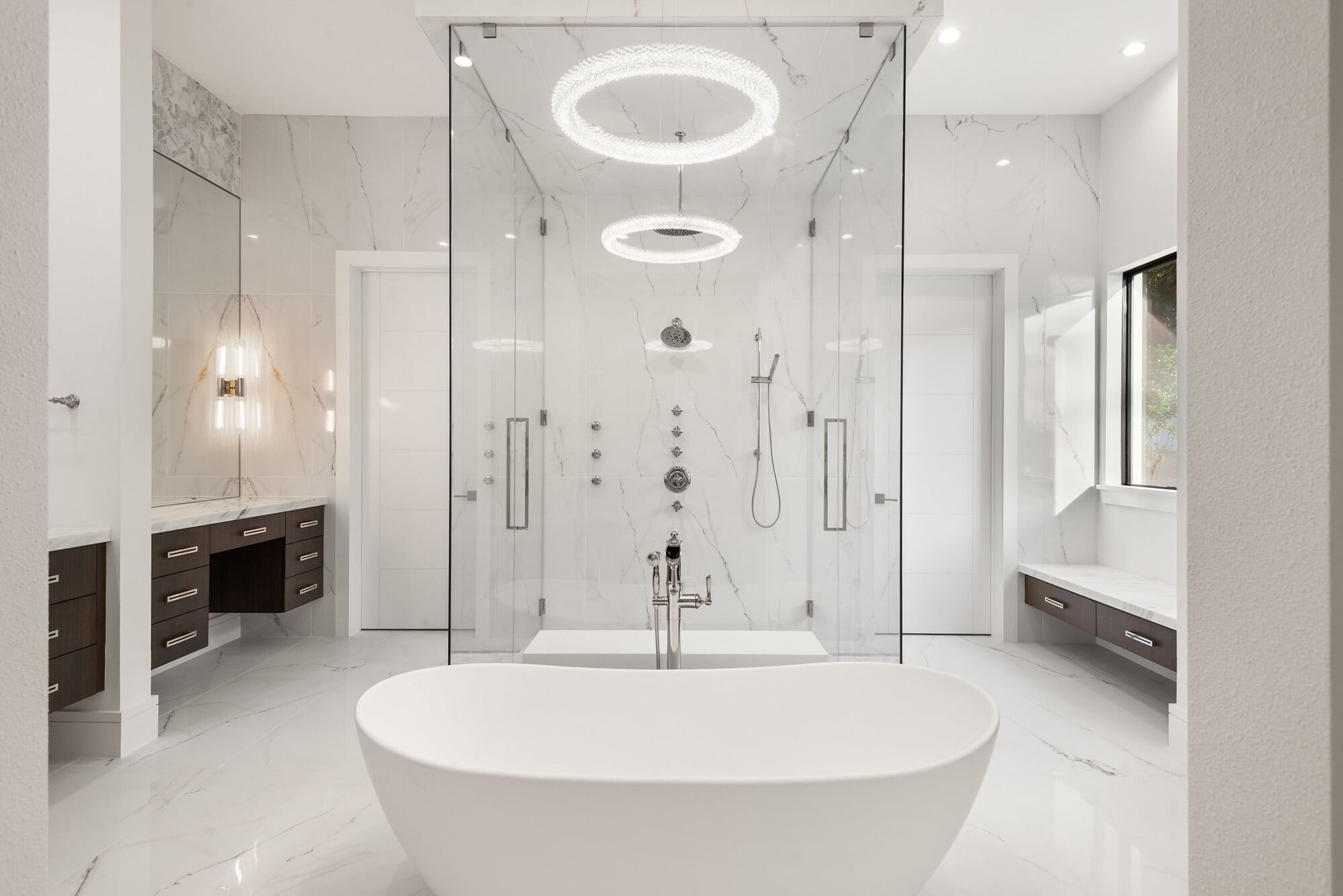 Luxury primary bathroom with freestanding soaking tub and glass-enclosed shower in a custom Bella Collina home
