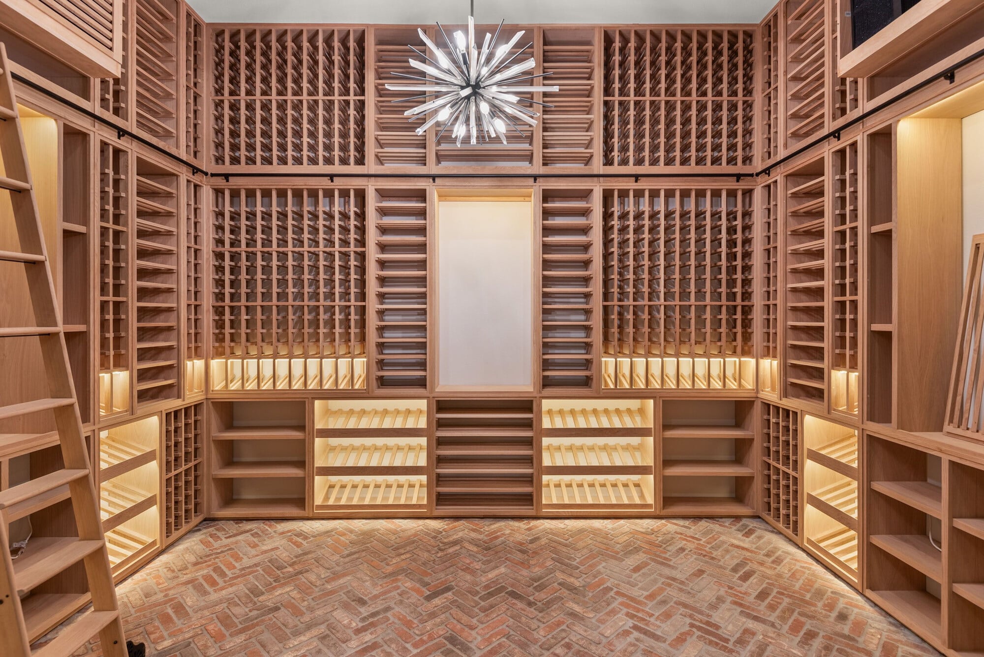 Custom wine cellar with floor-to-ceiling wood wine racks and display lighting in a Bella Collina home