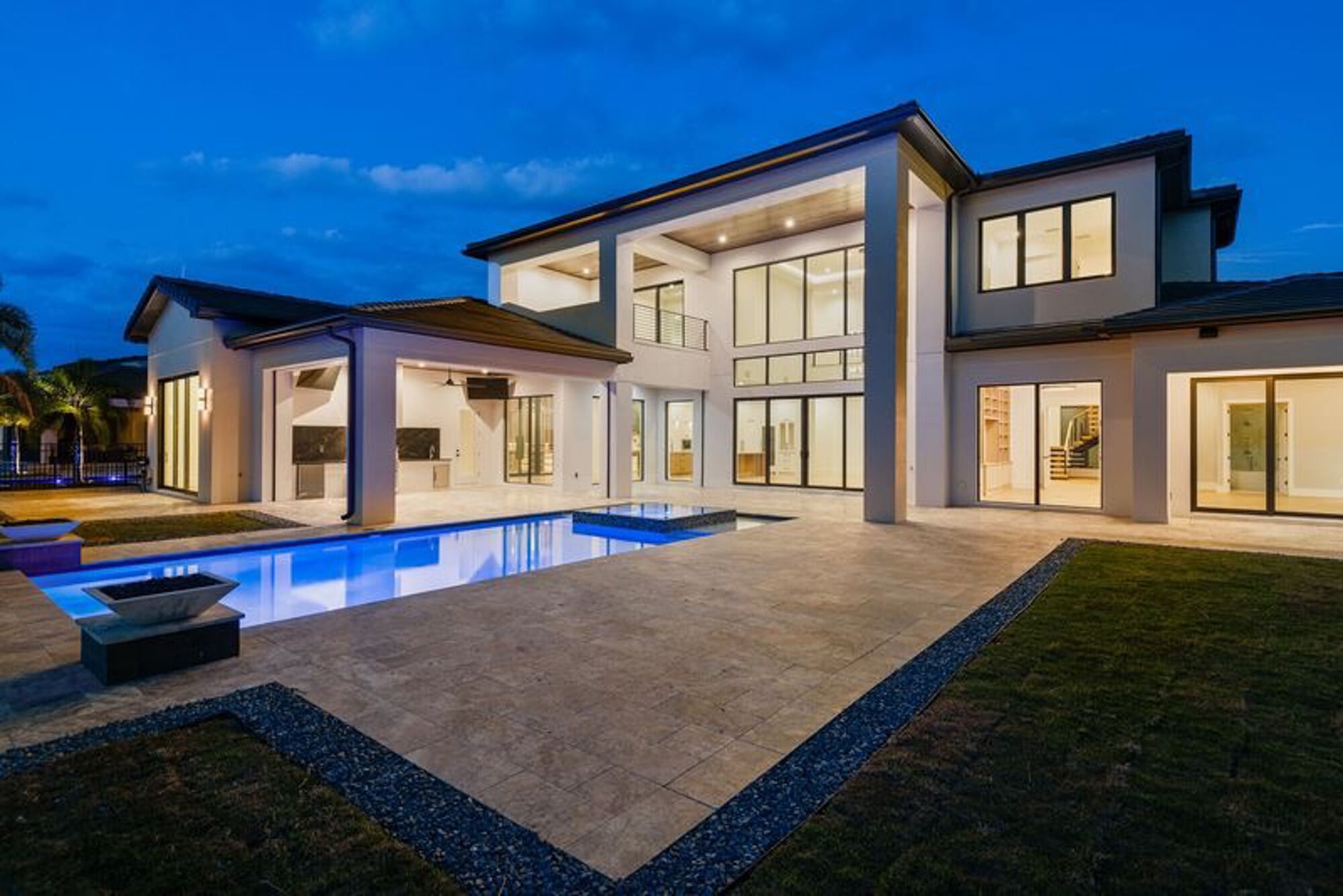 View of pool, deck, and rear of custom home at Bella Collina