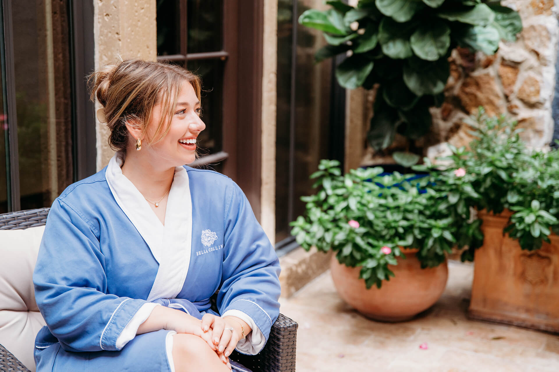 Woman in Robe Sitting at Spa Outdoor Zen Garden 