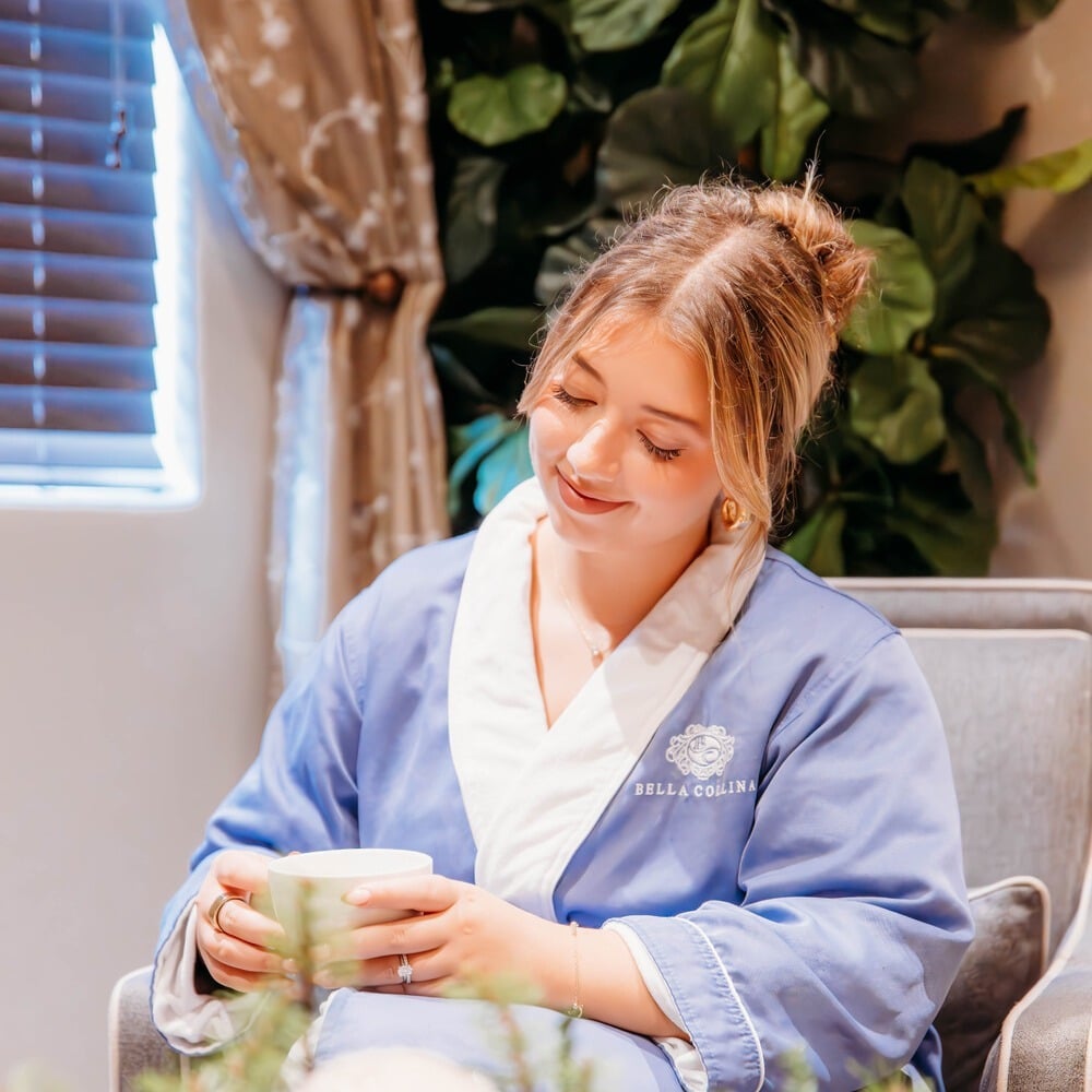Woman in robe relaxing at the Spa at Bella Collina