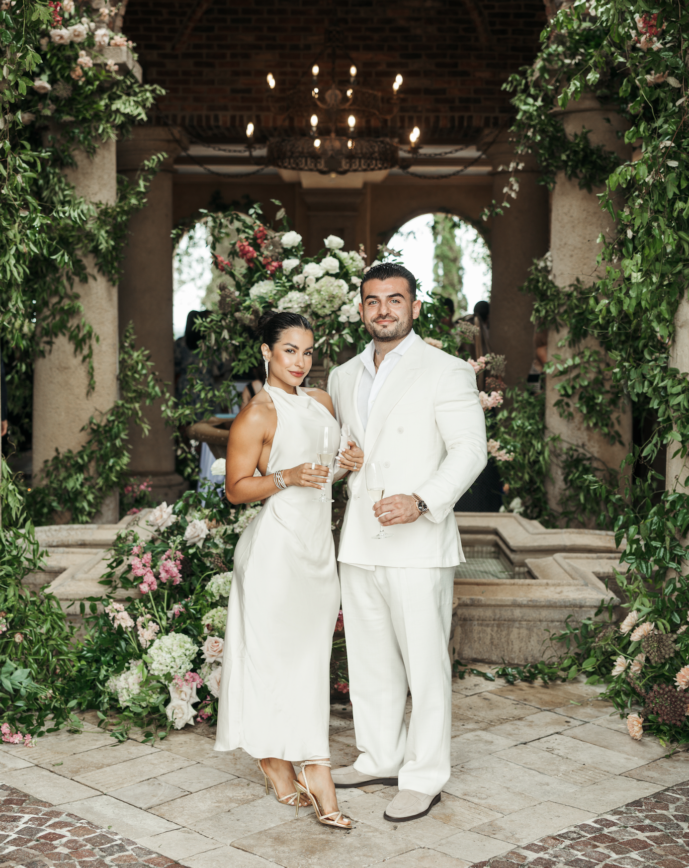 Couple standing in front of floral display at Bella Collina