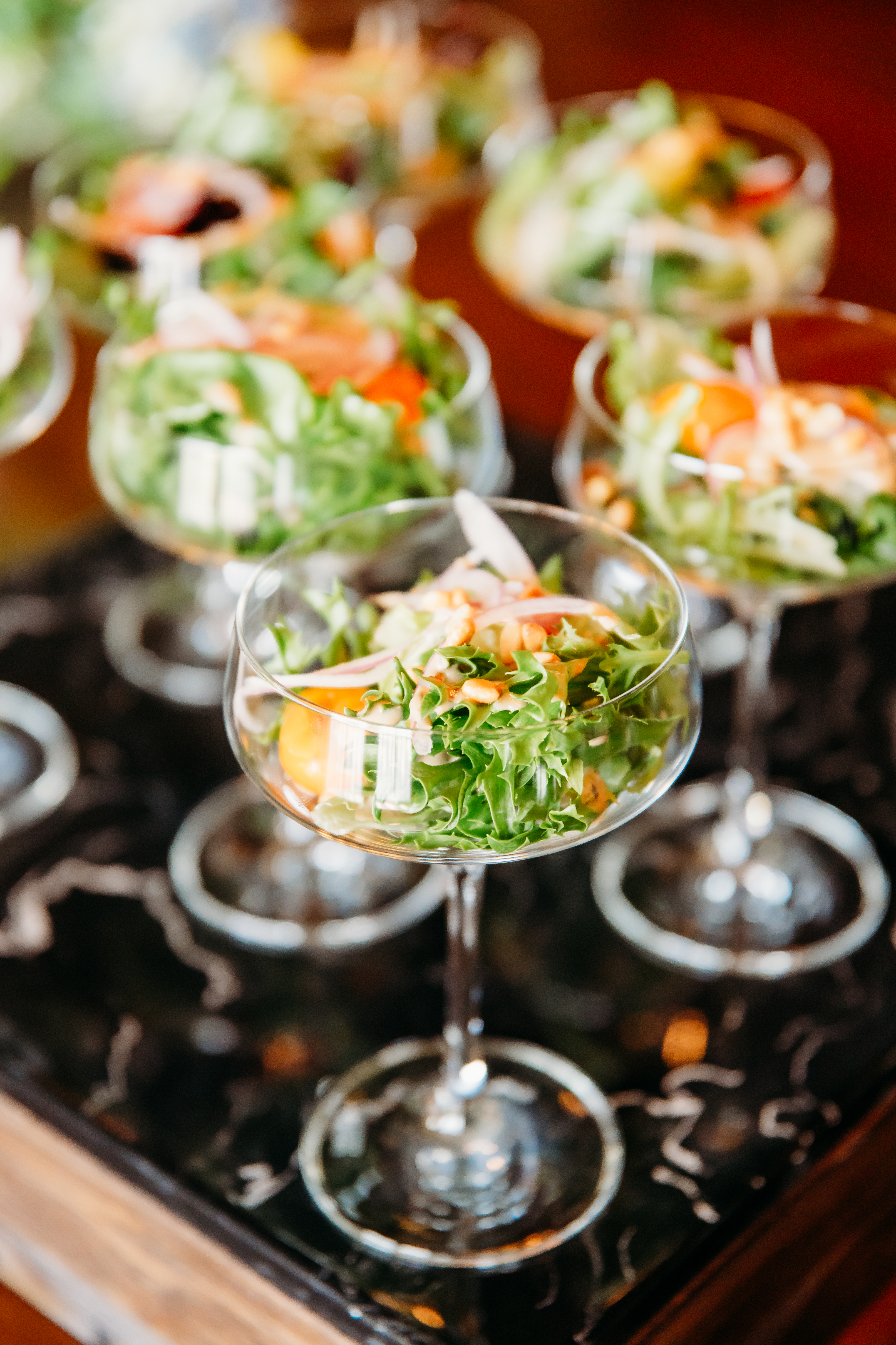 Individual salad appetizers served in stemmed glasses at a Bella Collina wedding reception