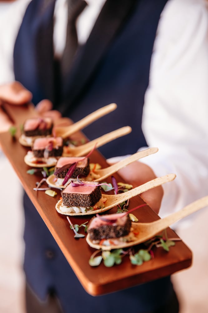 Seared appetizers served on wooden spoons at a Bella Collina wedding reception