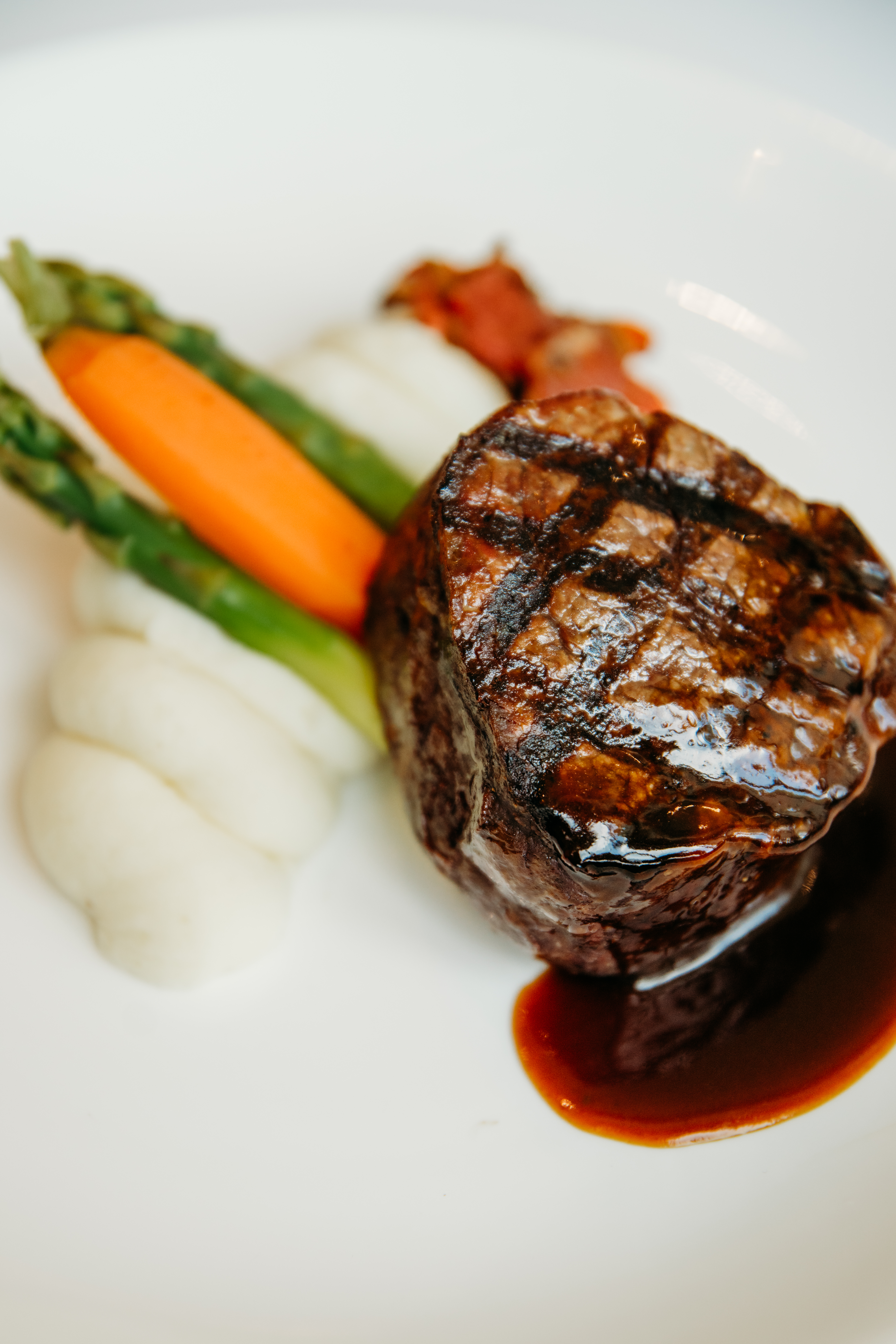 Grilled filet mignon with asparagus and vegetables at Bella Collina